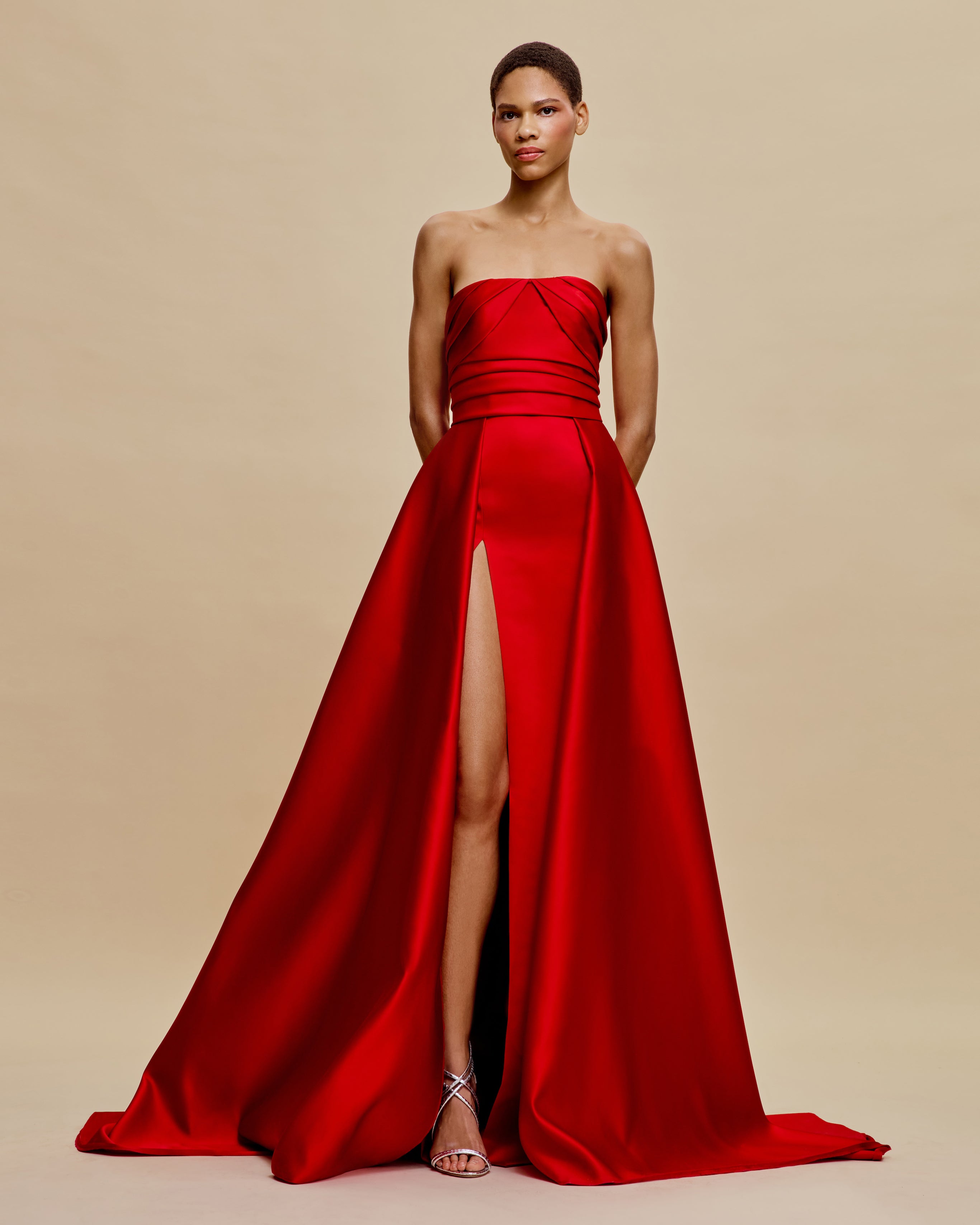 naeem khan red dress NAEEM KHAN PRE FALL 2026 Look 10 A strapless deep burgundy floor-length gown, featuring tonal chenille leaf motifs that enhance the silhouette with texture
